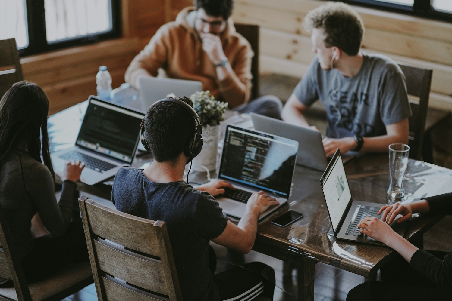 Colleagues sharing ideas around a table in a bright office